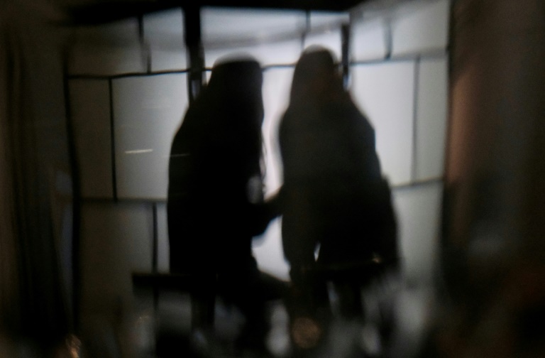 Des étudiantes de l'université de Hong Kong victimes de deepfakes pornographiques - B. et C. - regardent leur téléphone, le 29 juillet 2025 à Hong Kong