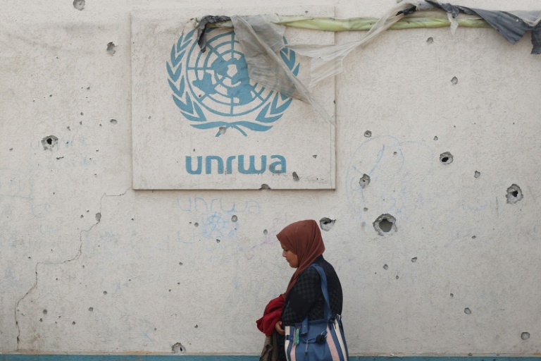 Le logo de l'Unrwa sur un mur criblé d'impacts dans un camp pour personnes déplacées à Rafah, dans le sud de la bande de Gaza, le 28 mai 2024
