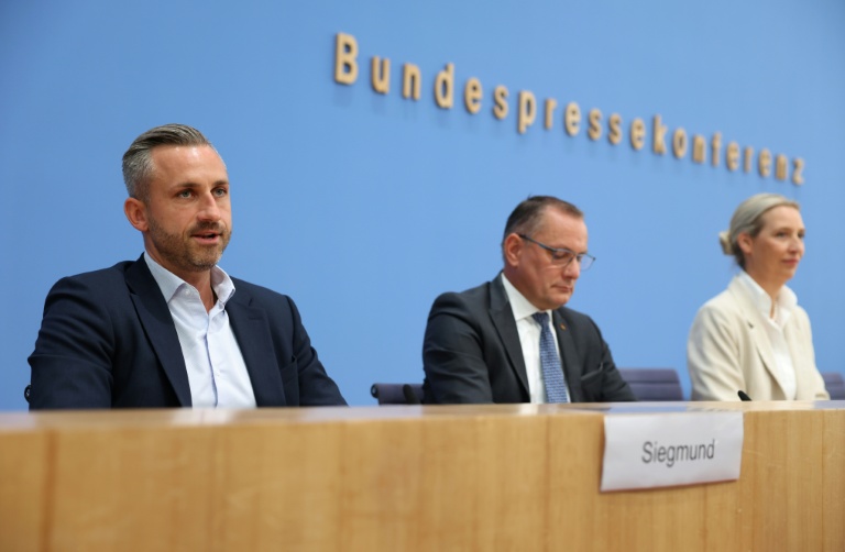 (g-d) Ulrich Siegmund, tête de liste du parti d'extrême droite Alternative pour l'Allemagne (AfD) aux élections régionales de Saxe-Anhalt, les coprésidents de l'AfD Tino Chrupalla et Alice Weidel et d'autres membres du parti chantent l'hymne national lors de la soirée électorale à Magdebourg, le 6 septembre 2026 dans l'est de l'Allemagne