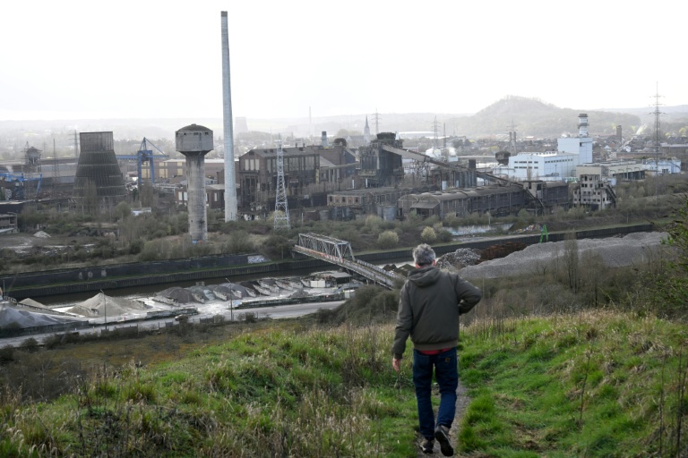 Un visiteur descend un terril près d'aciéries abandonnées à Charleroi, dans le sud de la Belgique, le 11 mars 2026