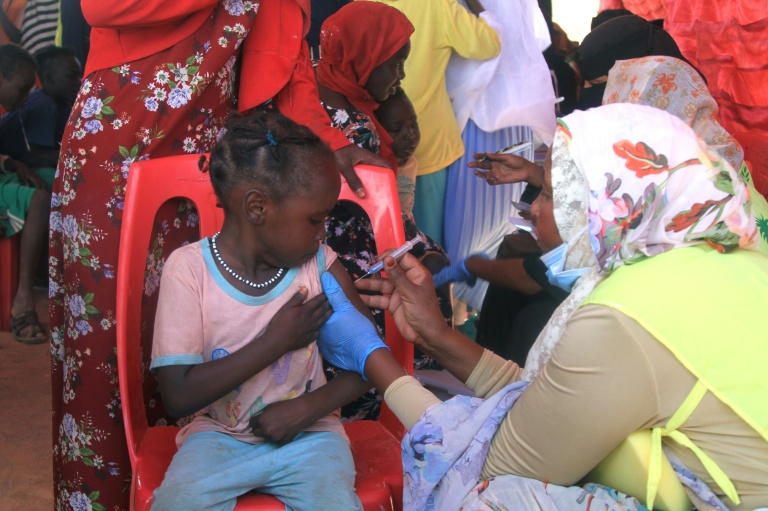 Une fillette soudanaise est vaccinée contre la diphtérie dans un camp de déplacés dans la ville d'Al-Dabbah, dans le nord du Soudan, le 22 novembre 2025