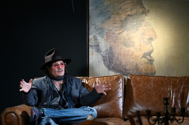L'acteur américain Johnny Depp devant l'un de ses tableaux lors d'une interview après une avant-première de son exposition 
