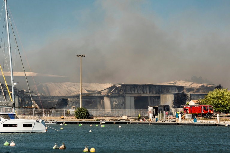 De la fumée d'incendie s'élève au dessus d'une entreprise de catamarans à Canet-en-Roussillon (sud) le 2 juillet 2026 