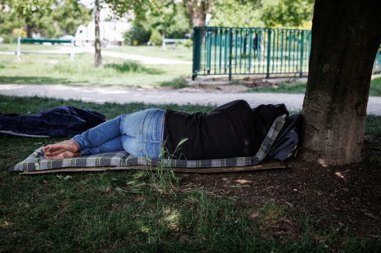 Une personne se repose à l'ombre dans un parc le 29 mai 2026 à Paris lors d'une vague de chaleur 