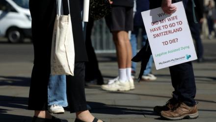 Des militants en faveur d'une modification de la loi sur l'aide médicale à mourir, rassemblés devant le palais de Westminster,le 24 avril 2026 à Londres