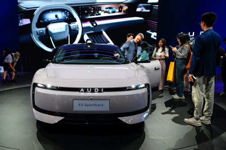 Des visiteurs découvrent le modèle E5 Sportback d'AUDI au salon de l'automobile de Shanghai, le 23 avril 2025