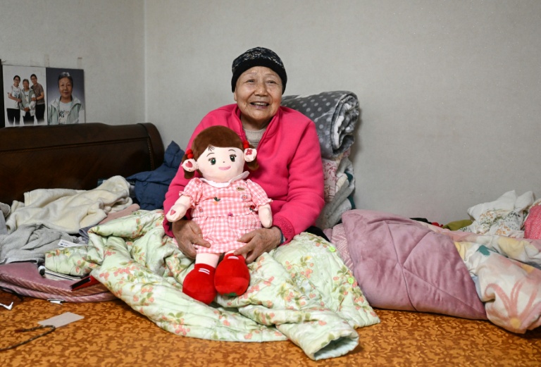 Kim Young-bun, une Sud-Coréenne de 79 ans vivant seule, pose avec sa poupée IA Hyodol le 29 mai 2026 Yongin, en Corée du Sud 