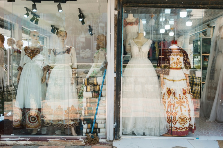 Des netela et des habesha kemis (vêtements traditionnels éthiopiens) dans la vitrine d'un magasin du quartier Shiromeda à Addis Abeba, le 7 octobre 2025 en Éthiopie