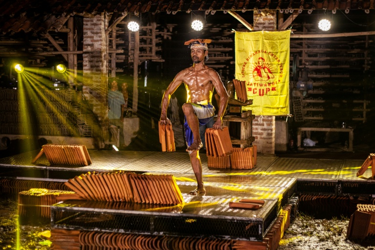 Un ouvrier particile à un concours de culturisme pour défendre la production de tuiles dans la ville indonésienne de Jatiwangi le 11 août 2025 