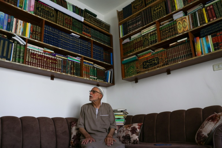 Mustafa Khaled Alwan devant sa bibliothèque, à son domicile à Homs, en Syrie, le 19 septembre 2026