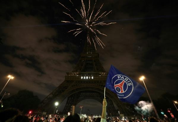 Un supporteur du Paris Saint-Germain agite un drapeau du club près de la tour Eiffel à Paris le 31 mai 2025