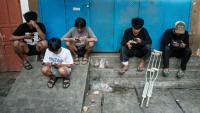 Des enfants utilisent leur smartphone à Jakarta le 26 mars 2026.