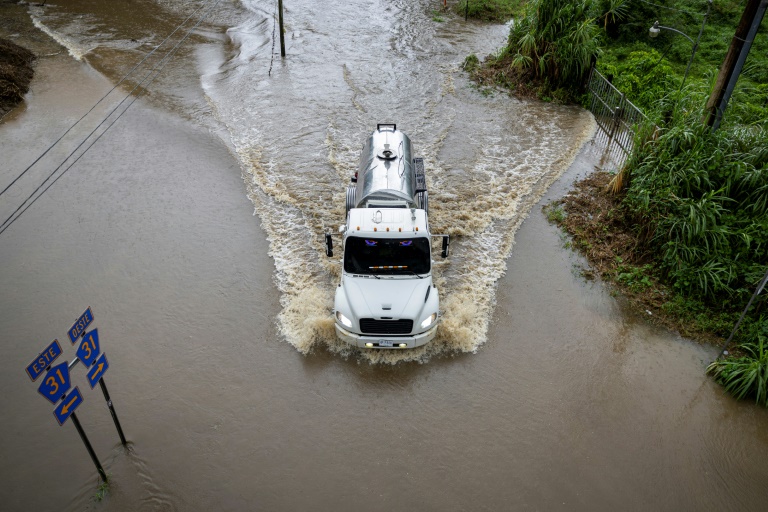 Un camion avance sur une route inondée, dans la région de Naguabo, à Porto Rico, le 16 août 2025
