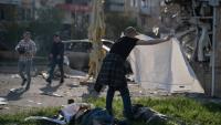 Un homme couvre d'un drap les corps de victimes de frappes russes à Kramatorsk, dans l'Est de l'Ukraine, le 5 mai 2026