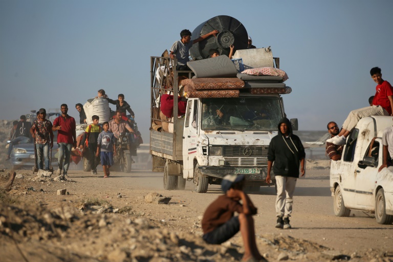 Des Palestiniens marchent le long de la route côtière dans le centre 
de la bande de Gaza en direction de la ville de Gaza, dans le nord, le 11 
octobre 2025