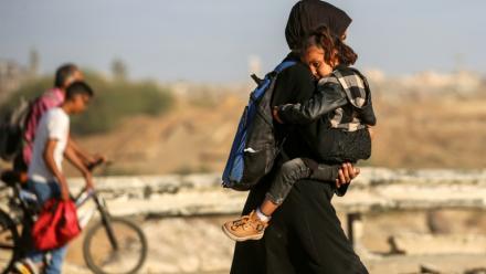Des Palestiniens marchent le long de la route côtière dans le centre de la bande de Gaza en direction de la ville de Gaza, dans le nord, le 11 octobre 2025