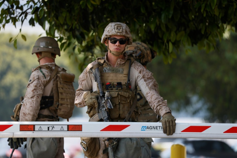 Des Marines gardent l'entrée d'un parking devant le Wilshire Federal Building à Los Angeles, Californie, le 13 juin 2025.