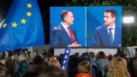 Des partisans du maire de Varsovie pro-européen, Rafal Trzaskowski (d), observent un débat entre leur candidat et son principal adversaire à la présidentielle, le nationaliste Karol Nawrocki (g), à Varsovie, le 12 mai 2025