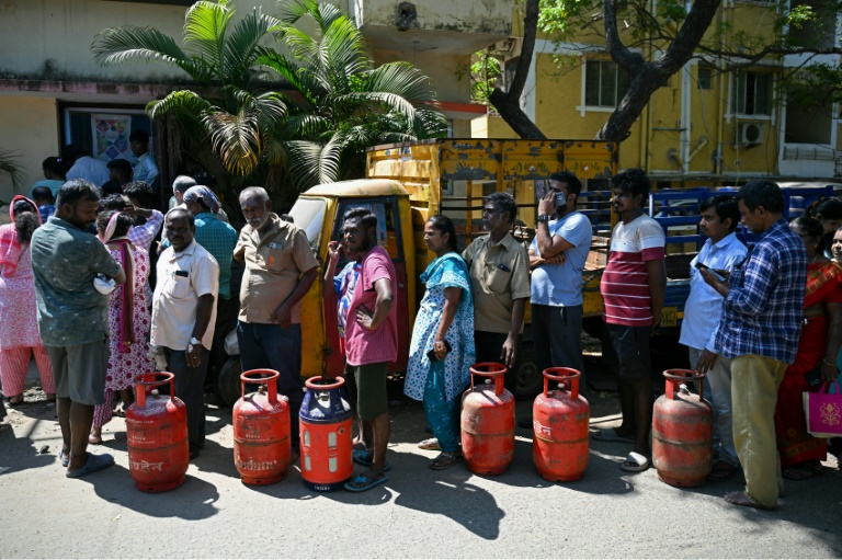Des personnes font la queue pour acheter des bouteilles de gaz de pétrole liquéfié (GPL) à usage domestique, devant un bureau d'agence de gaz, le 11 mars 2026 à Chennai (Inde)
