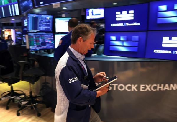 Trader sur le parquet du New York Stock Exchange (NYSE), le 14 mai 2026