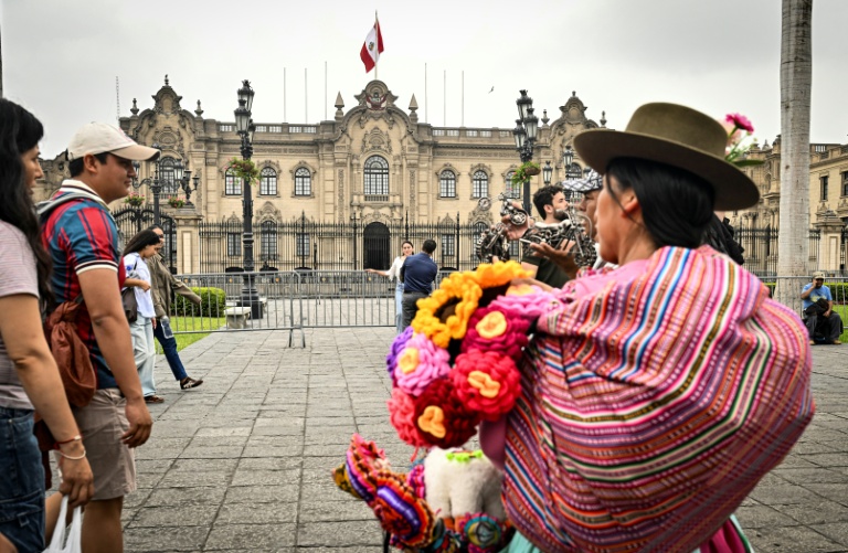 Des passants sur la Plaza de Armas de Lima, devant le palais présidentiel, le 6 juin 2026, avant le second tour de l'élection présidentielle