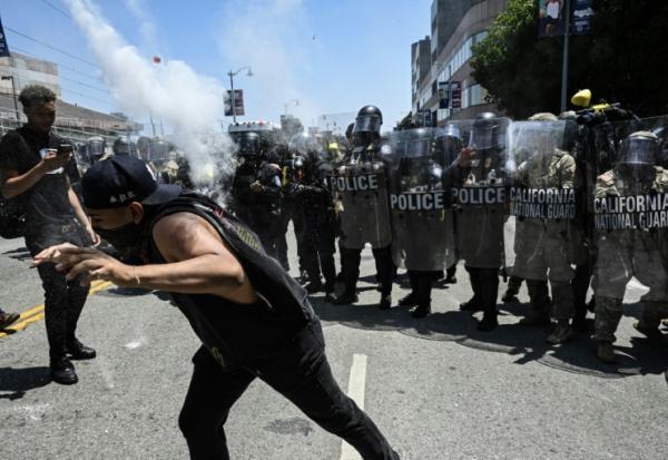 Des agents des forces de l'ordre tirent des gaz lacrymogènes pour repousser des manifestants, le 10 juin 2025 à Los Angeles