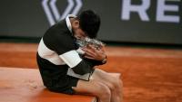 L'Espagnol Carlos Alcaraz enlace le trophée de Roland-Garros après sa victoire en finale sur l'Italien Jannik Sinner, le 8 juin 2025 à Paris