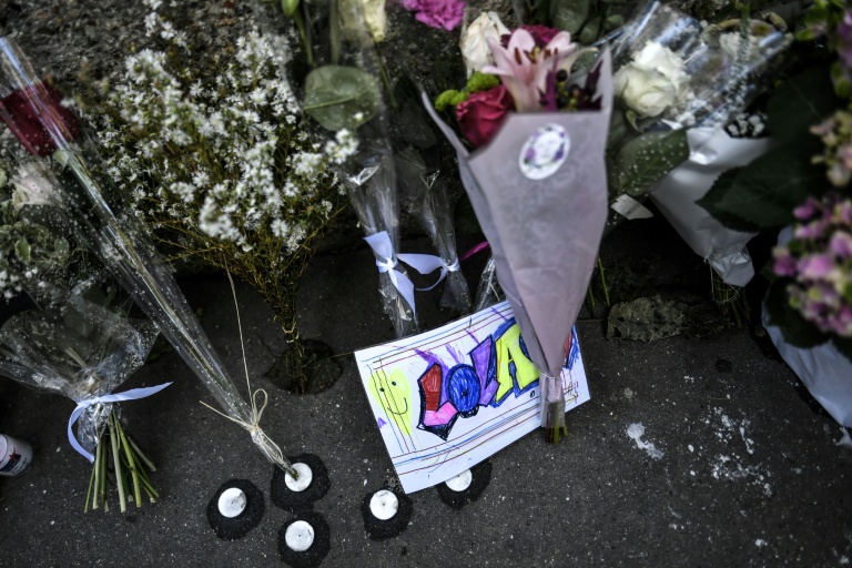 Des fleurs et des cartes déposées devant l'immeuble où résidait Lola, le 20 octobre 2022, à Paris