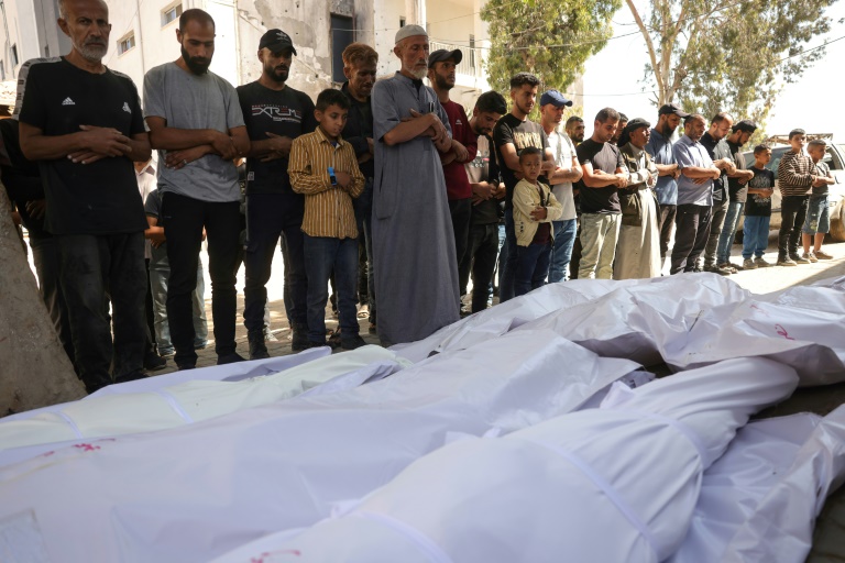 Des Palestiniens prient devant les corps de victimes des frappes israéliennes nocturnes, à l'hôpital Al-Chifa de la ville de Gaza, le 30 mai 2025