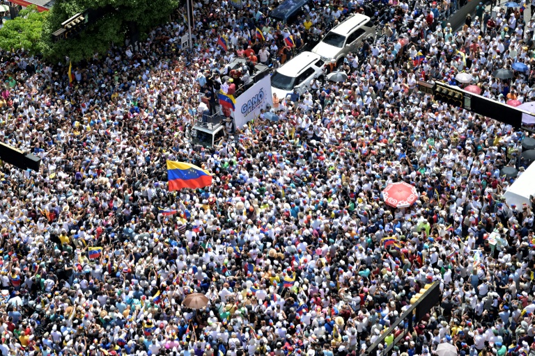 Des milliers de personnes participent à une manifestation organisée par la cheffe de l'opposition vénézuélienne Maria Corina Machado (au centre, sur un camion) à Caracas, le 17 août 2024